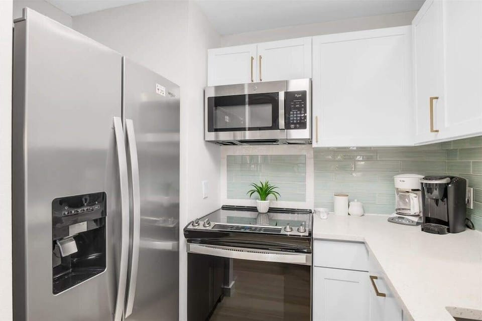 Kitchen: Keurig, drip coffee maker, blender, toaster, cooking utensils, tableware
