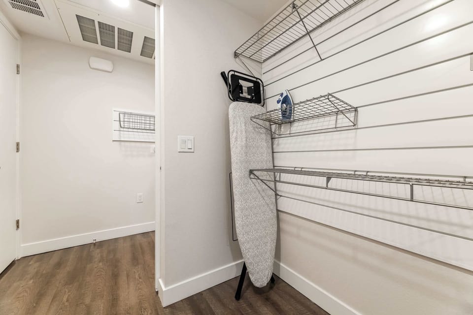 Bright dressing corridor, designed for convenience and comfort with modern shelving — ideal for extended stays and effortless organization.