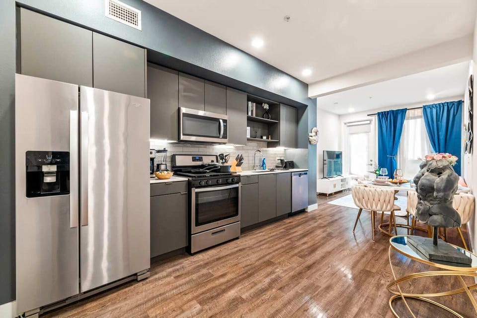 Bright, contemporary cooking space featuring integrated appliances and modern lighting, where elegance meets functionality.