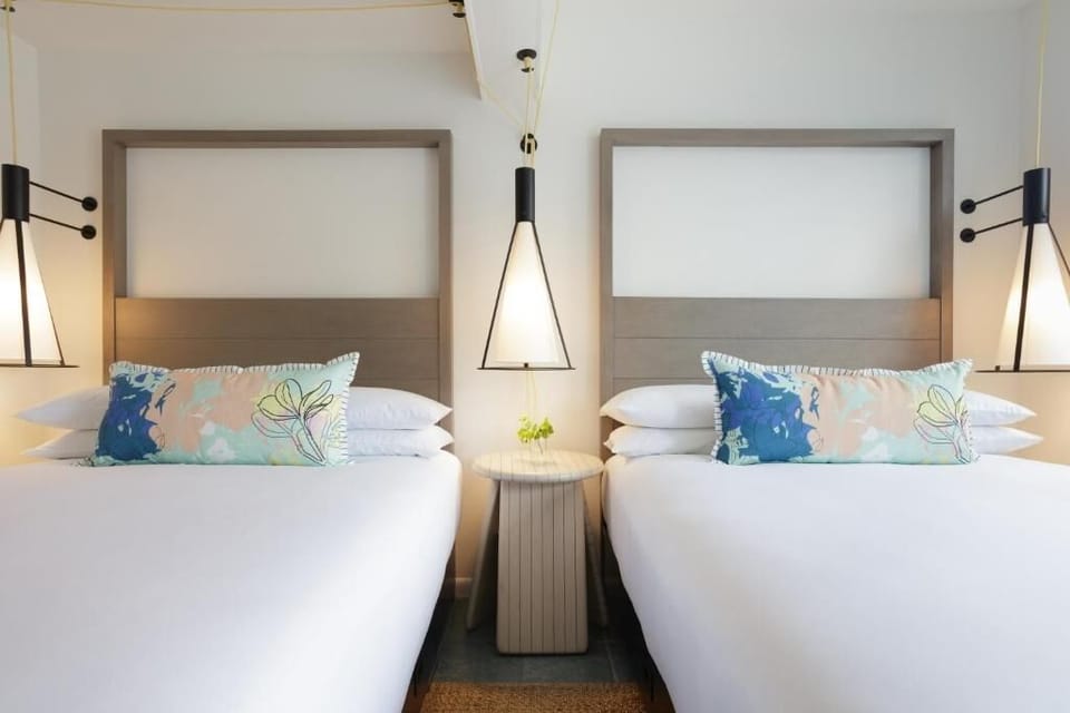 Drift off beneath warm pendant lights and plush pillows.