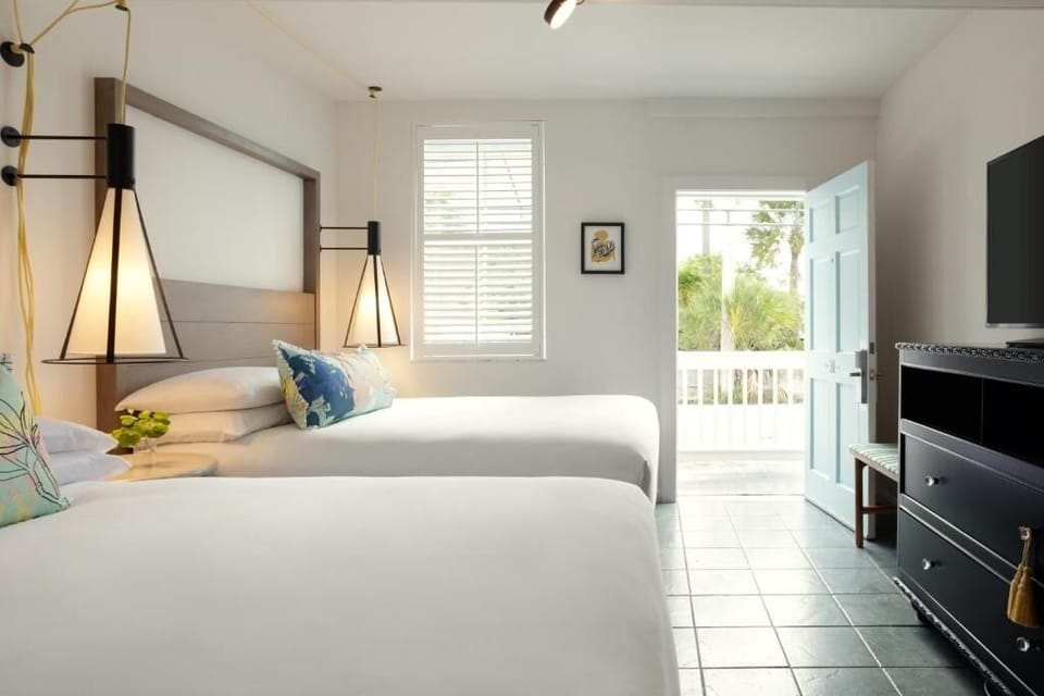 Unwind in airy comfort with balcony breezes and crisp linens.