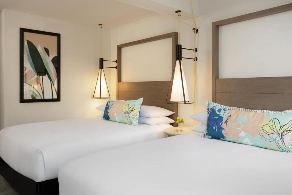 Recharge in a serene double-bed retreat with modern lighting.