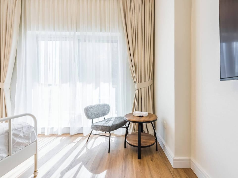 A comfortable chair paired with a stylish coffee table and a wall-mounted TV creates a cozy spot to relax and unwind.