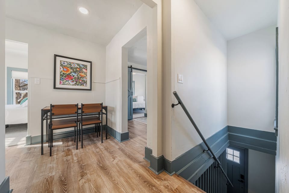 - Hallway dining area featuring compact wooden table and modern layout   - Wood floors and soft lighting connect every room with harmony   - Perfect spot to enjoy quick meals or plan your next adventure
