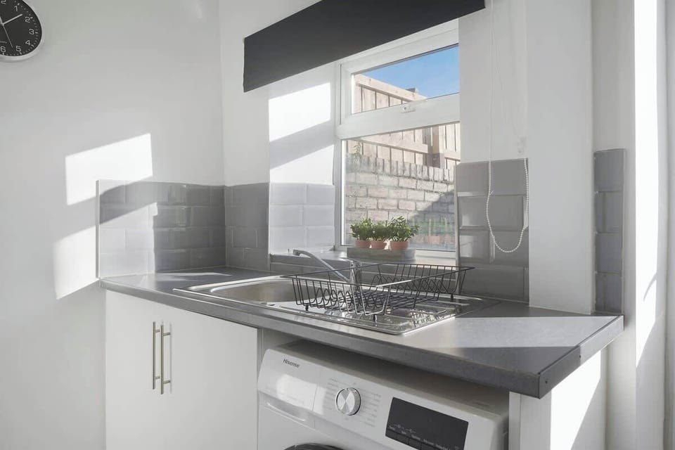 Kitchen equipped with all essentials, including a washer & dryer, oven, fridge and full cookware set.