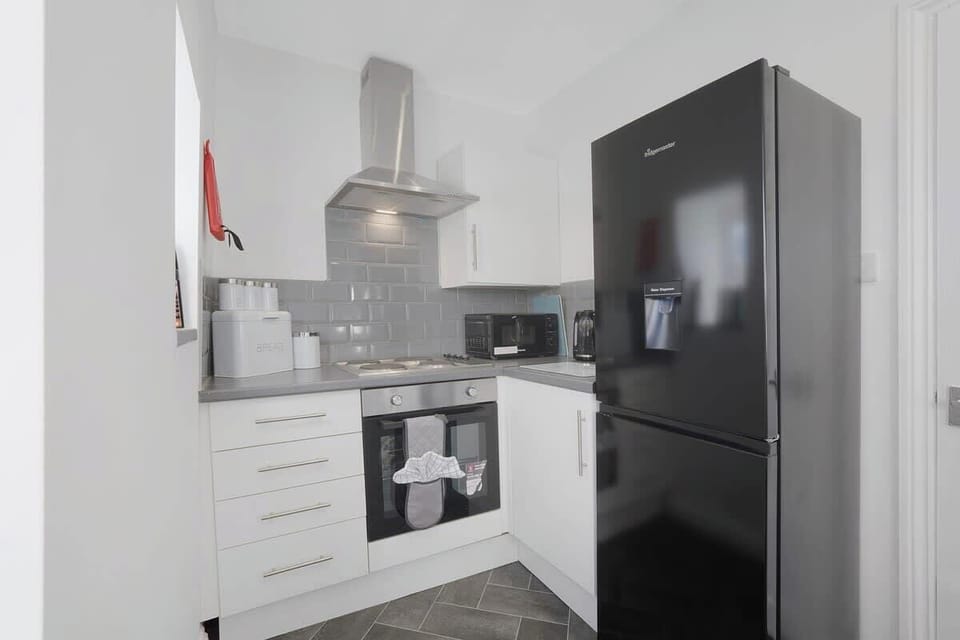 Kitchen equipped with all essentials, including a washer & dryer, oven, fridge and full cookware set.