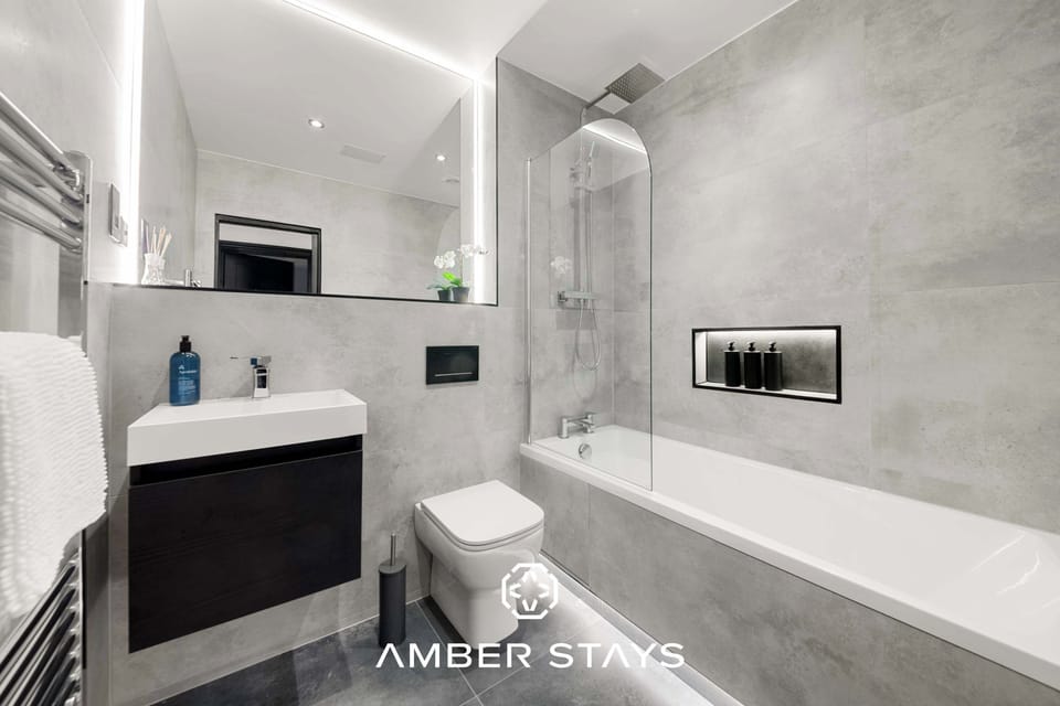 Featuring sleek finishes and a calming ambiance, this full bathroom offers a perfect space to unwind with a refreshing shower or a relaxing soak.
