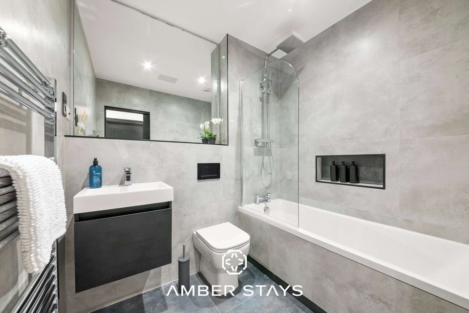 Featuring sleek finishes and a calming ambiance, this full bathroom offers a perfect space to unwind with a refreshing shower or a relaxing soak.
