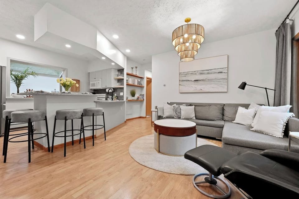 Modern open-concept kitchen with breakfast bar and cozy living area