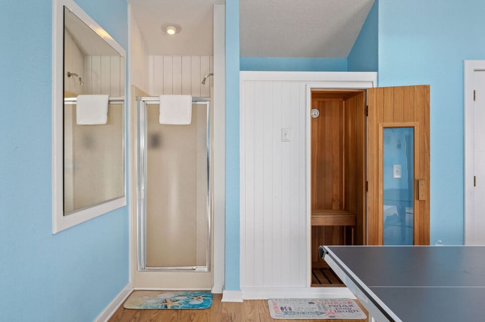Clean bath area w/ walk-in shower & a cozy wood sauna tucked just off the room.