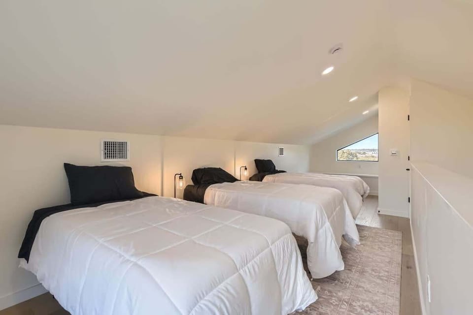 A clean, classic room with 3 single  beds and simple decor, offering a restful night’s sleep and relaxation.