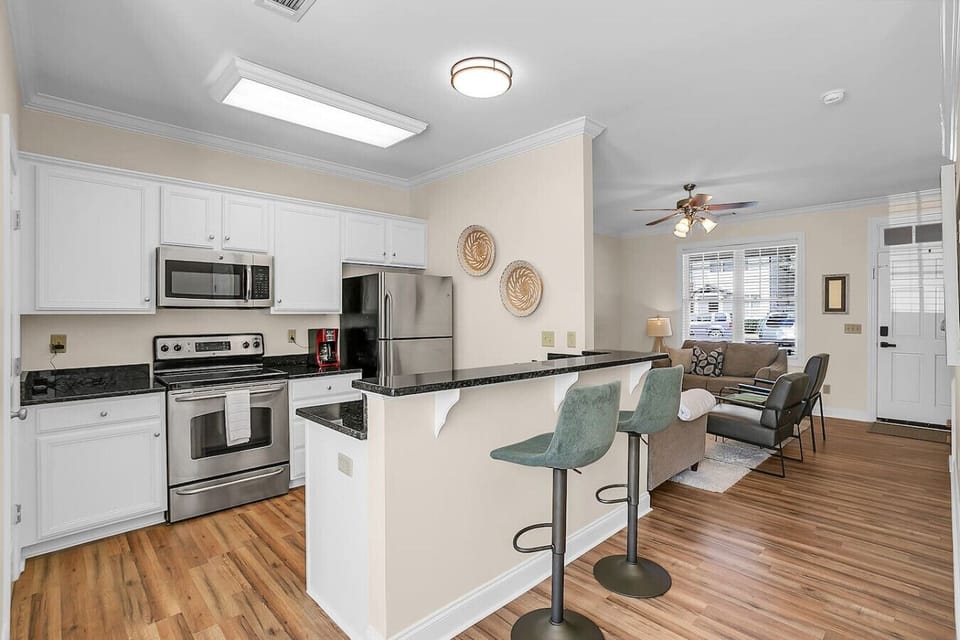 Look left to find the kitchen, equipped with stainless steel appliances including a fridge & freezer, electric stove top & oven, dishwasher, and microwave. A coffee maker is also available for your convenience!