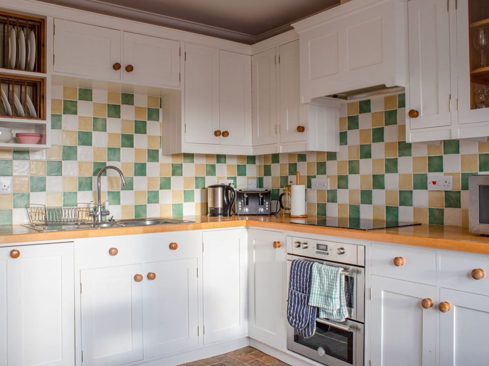 Kitchen, Interior Design, Countertop, Flooring, Kitchen Appliance, Cabinetry, Room, Tile, Major Appliance, Tap