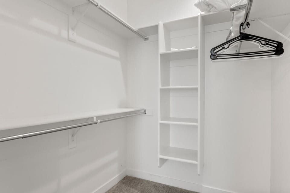 Large walk in closet with built in shelving