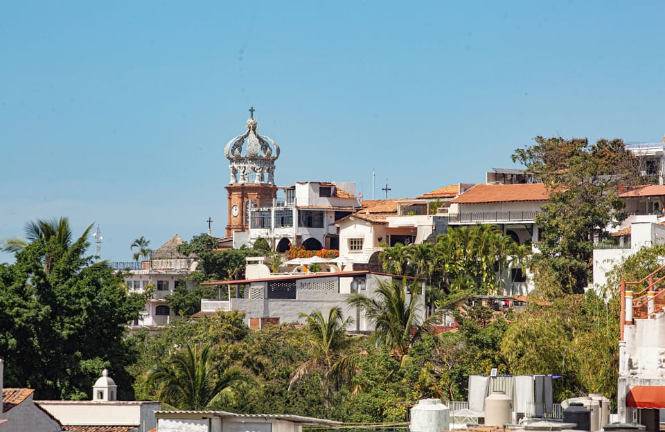 The iconic Our Lady of Guadalupe Church is clearly visible from the balcony.