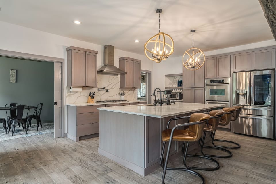 Modern kitchen with elegant lighting and a spacious island for gathering.
