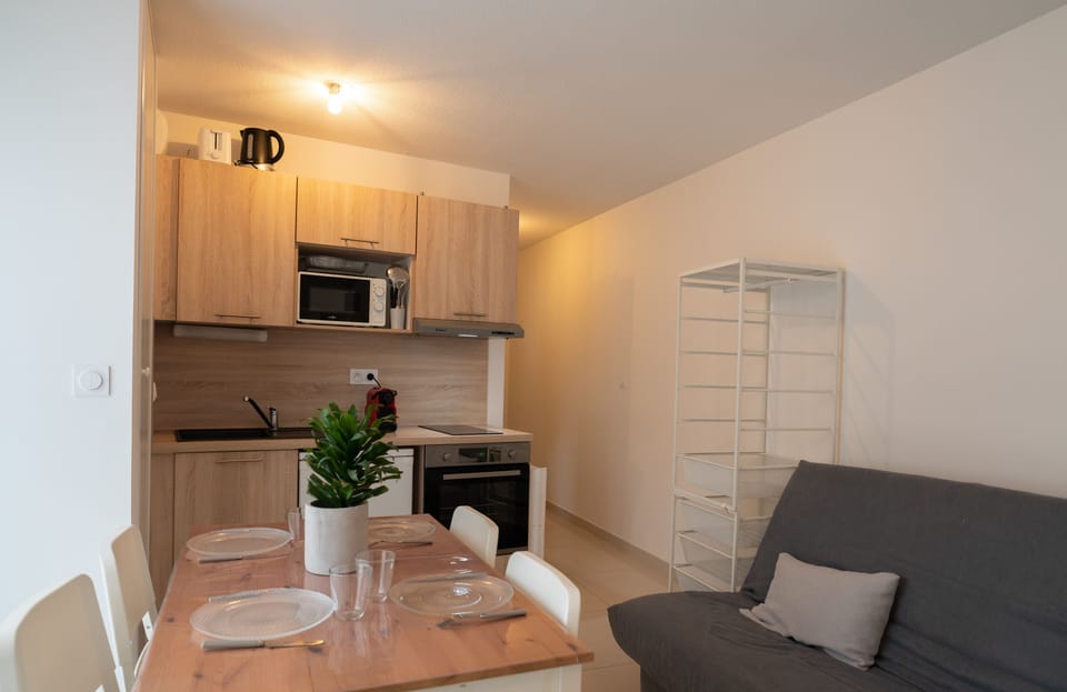 Fitted kitchen opening onto the living room and balcony