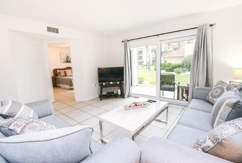 Living Room with view of Master Bedroom and Sliding Door to Outdoor Patio