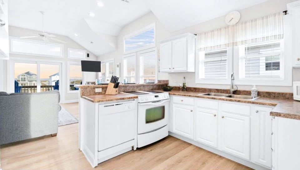 Bright, fully equipped kitchen with ocean views, perfect for cooking and dining.