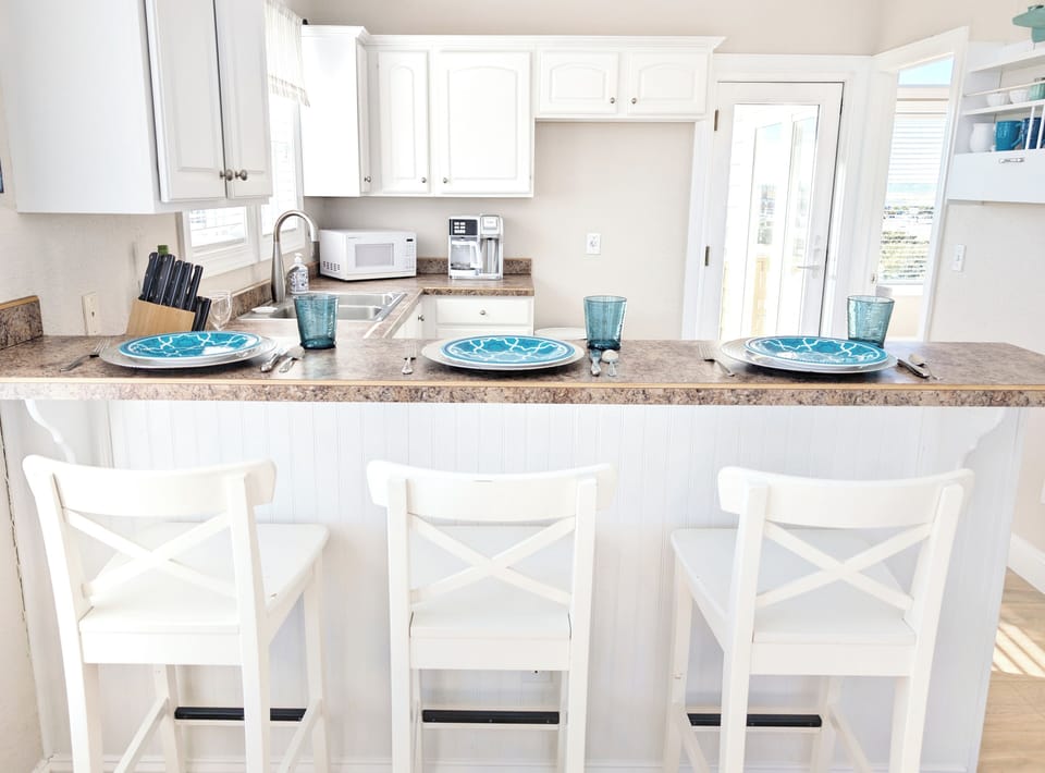 Charming breakfast bar with seating for three, ideal for casual meals and snacks