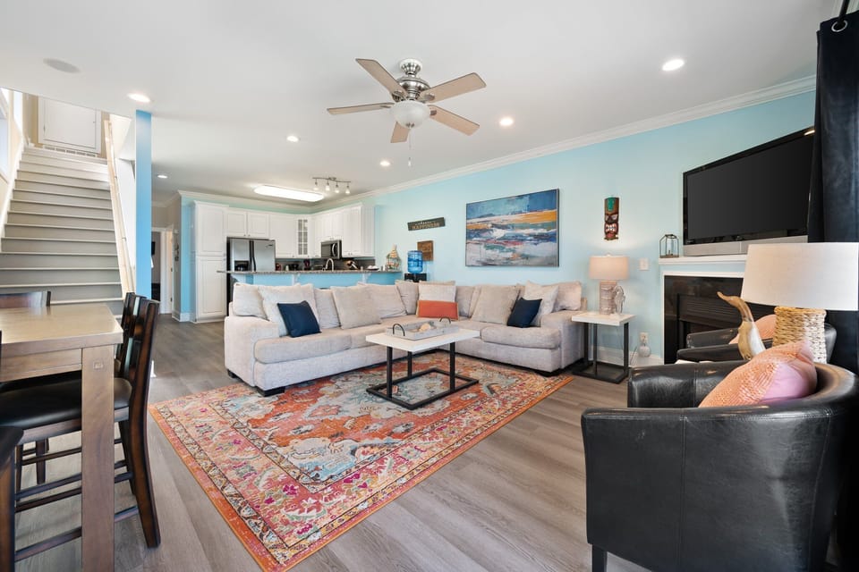 Relax in your bright, coastal-inspired living space with plush sectional seating and ocean artwork creating the perfect beach getaway vibe.