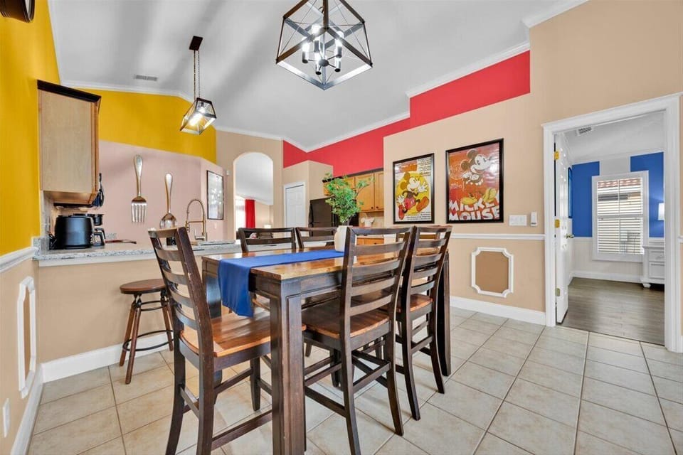 Table near kitchen next to bar with 3 bar stools