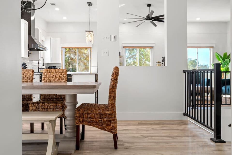 A sneak peek of the dining room, with stairs leading downstairs and a glimpse of the kitchen beyond!