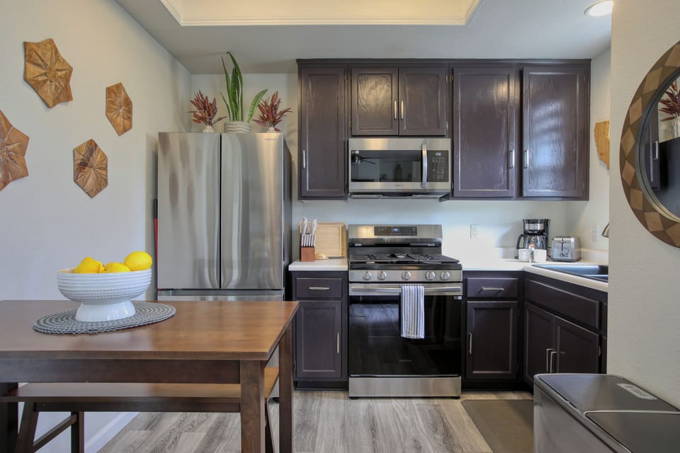 The fully equipped kitchen has a refrigerator, stove and oven, microwave, coffee maker, and dish ware—everything you need to whip up meals or enjoy a fresh cup of coffee before heading to the beach.