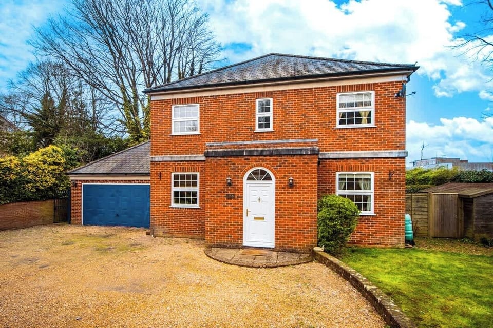 Front view of the entrance to the home. With large double garage, font garden space and parking for the whole group