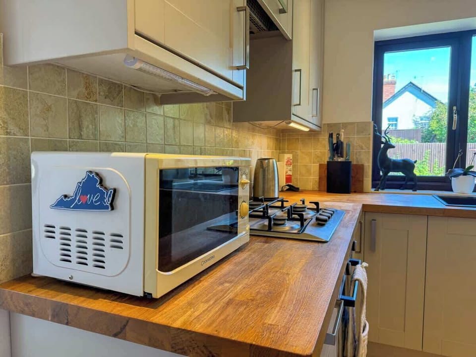 Everything you need for a perfect meal—oven, stove, and kettle, all in one cozy kitchen setup.