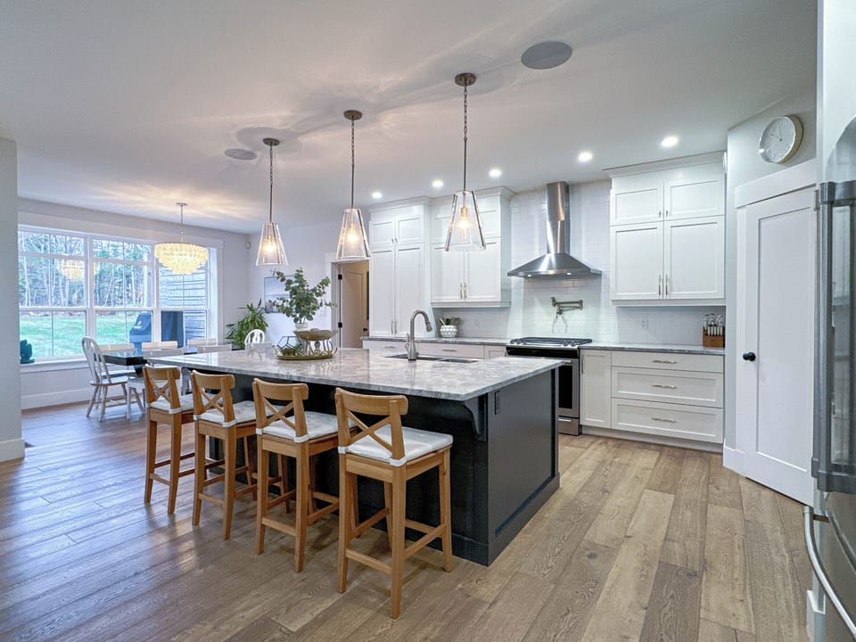 Chef's kitchen with a large kitchen island and partially stocked pantry.