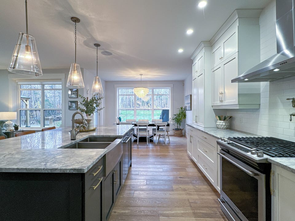 Chef's kitchen with a large kitchen island and partially stocked pantry.