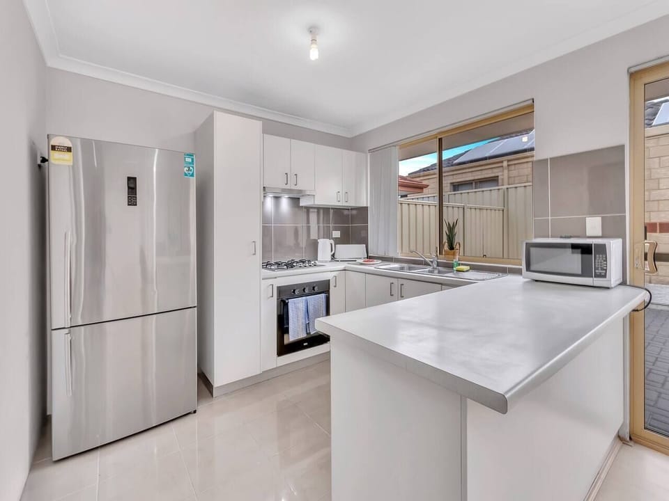 Whip up your home meals in this compact yet well-equipped kitchen, complete with a spacious bench and all the essentials.