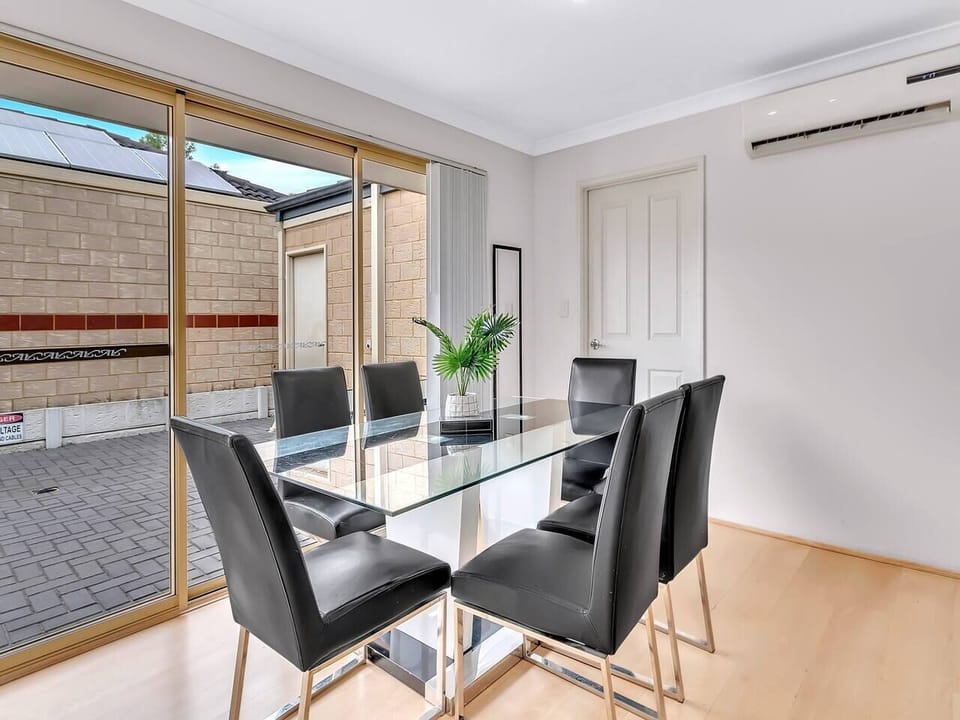 Dine in comfort at the six-seater glass table with patio access and split-system climate control.