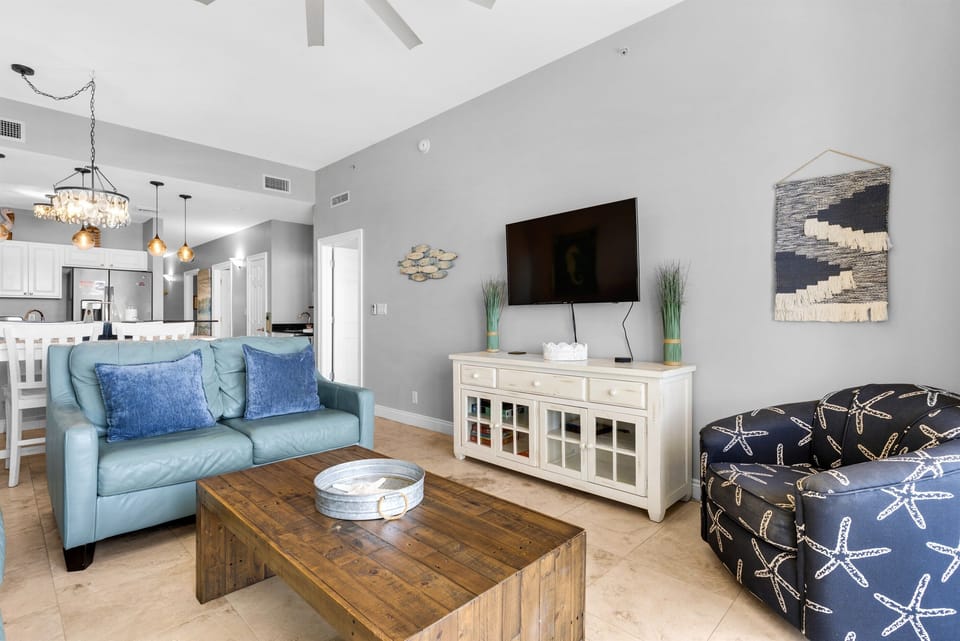 Living Room - Kick back in this bright living room with a comfy sofa and love seat, and a large comfy chair—ample seating for family and friends, with a queen sleeper sofa.