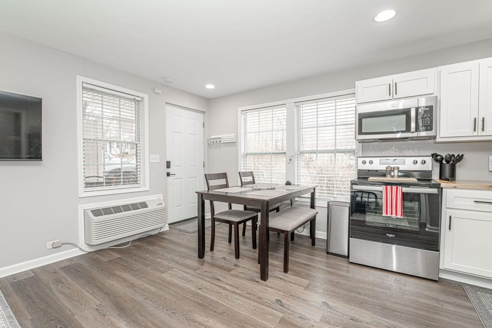 Cozy studio living with a kitchen and dining space for four. Perfect for shared meals and relaxation