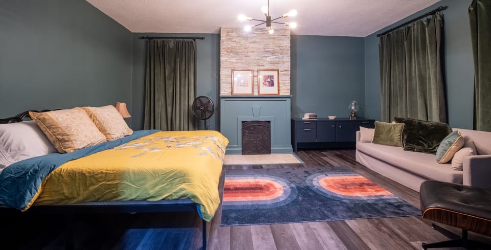 The upstairs master bedroom has a king bed, huge couch and space to relax.