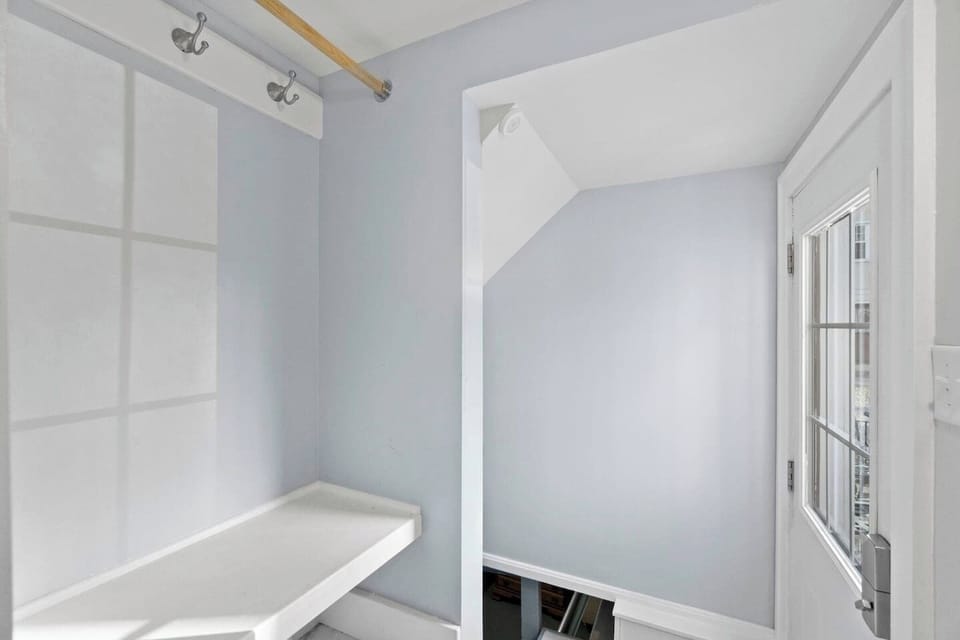 Small room with wall hooks and a built-in bench