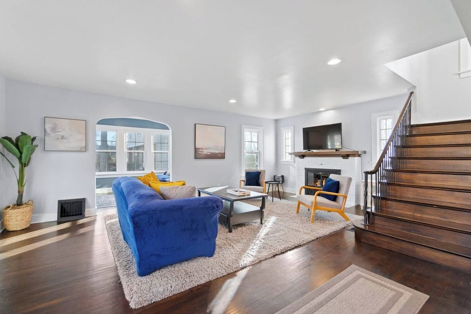 Bright, bold, and full of personality! This spacious living room with a vibrant blue couch and cheerful yellow accents is the perfect place to relax and enjoy your atmosphere.