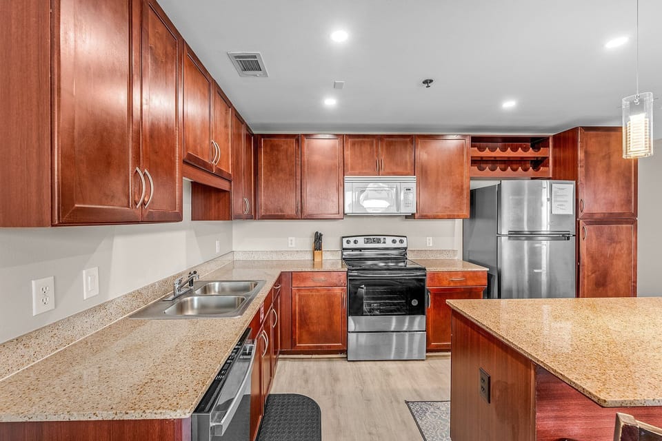 Modern kitchen with stainless steel appliances and granite countertops