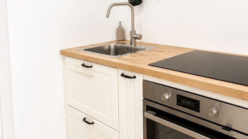 Fully equipped kitchen with modern appliances, induction cooktop, oven, and everything needed to prepare meals during your stay.