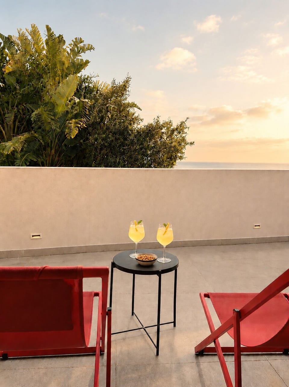 Sun loungers on the 65 m² private terrace, facing west — where the day ends with a golden light.