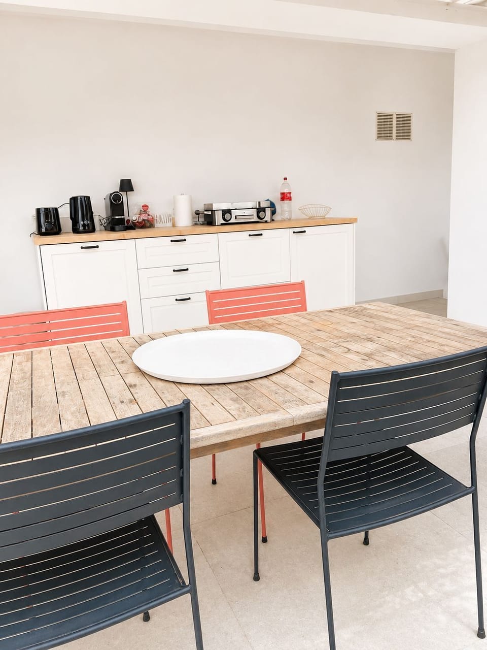 Outdoor/Indoor dining area with seating for up to six guests, complete with coffee-making facilities and a shaded terrace ideal for breakfast, lunch, or dinner.