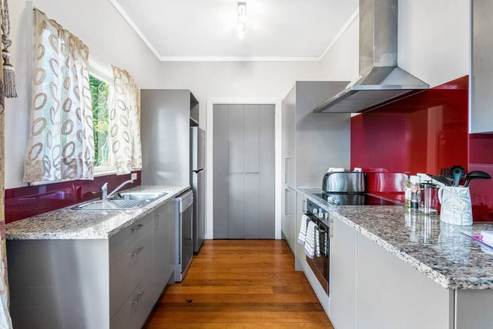 The kitchen has a oven, cooktop, dishwasher and microwave.
