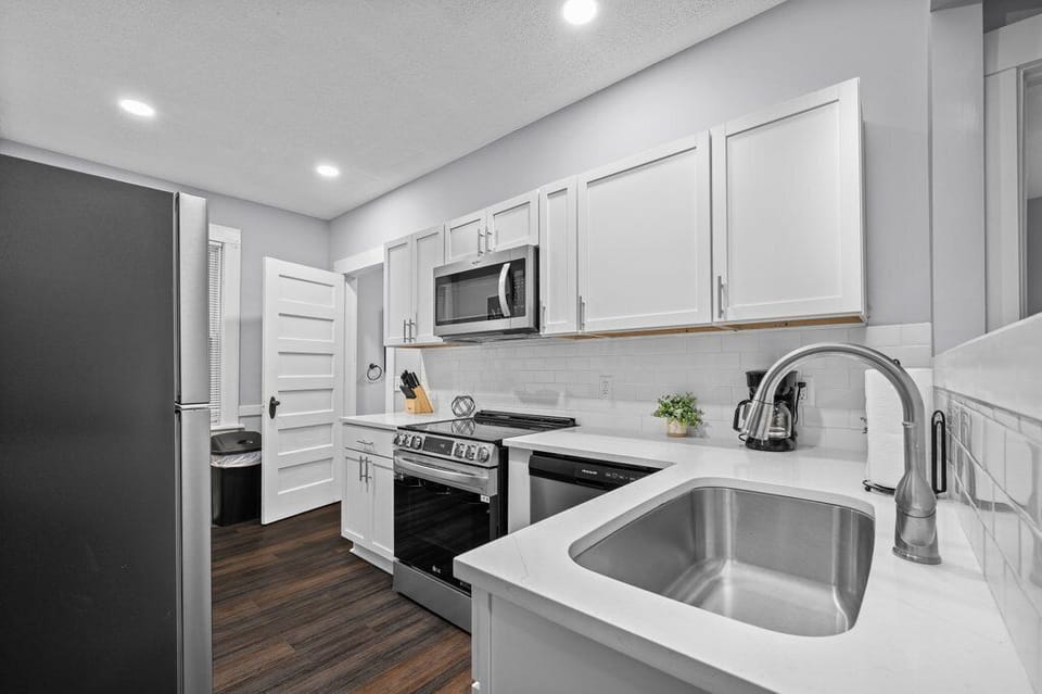 Well-equipped kitchen showcasing stainless steel appliances and plenty of counter space