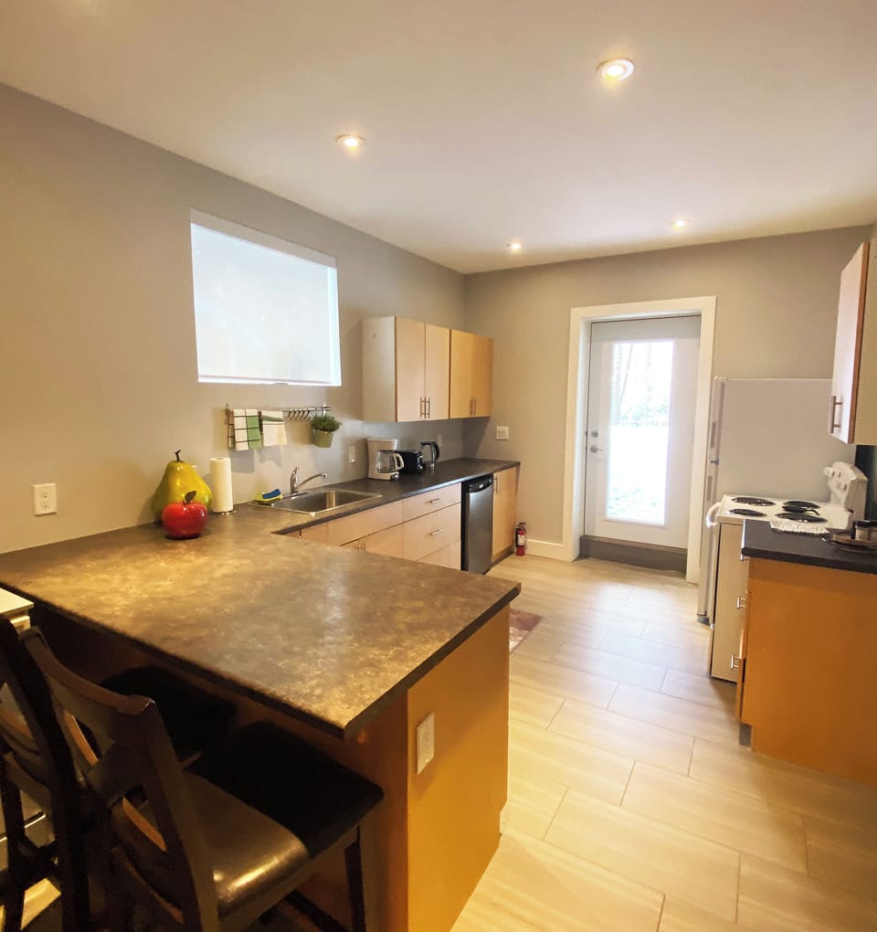 Large full kitchen with walkout to backyard and BBQ