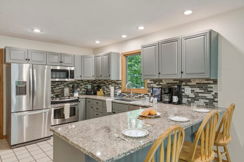 Cook, snack, and gather in this spacious kitchen with island seating, modern appliances, and everything you need for easy meals together.