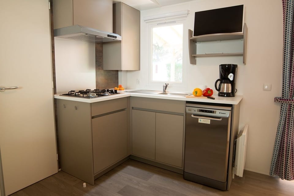 Fully equipped kitchenette featuring a dishwasher and all the essentials for a comfortable stay.