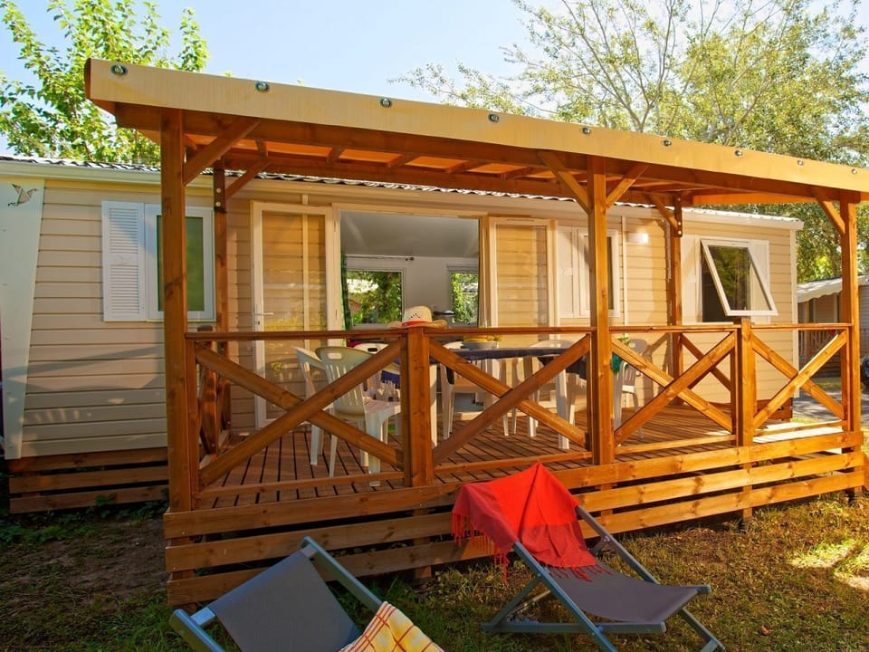"Relax on your covered terrace with comfortable seating, perfect for unwinding outdoors.