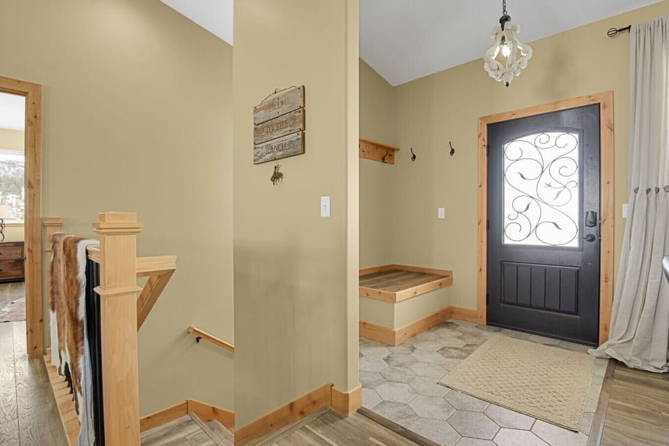 Main entryway has rack for your coats and bench to easily take off your boots
